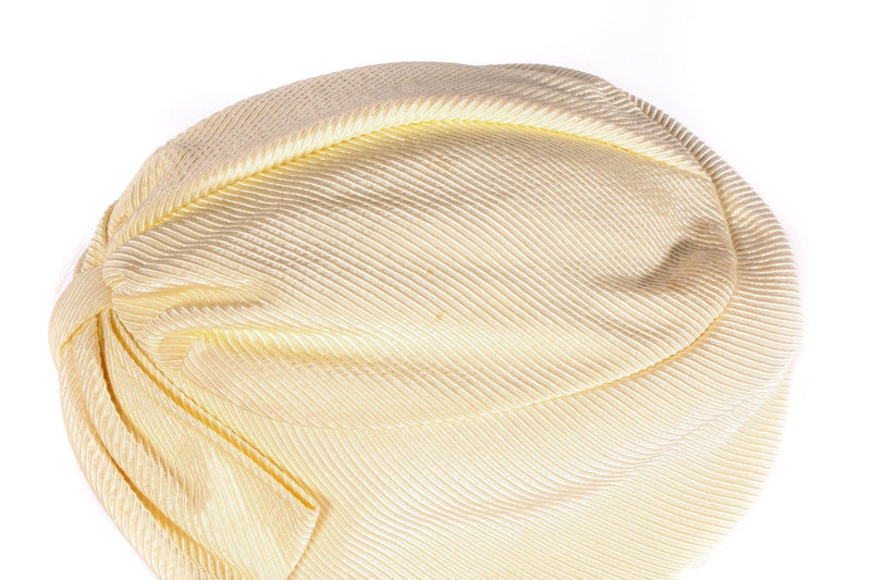 Light yellow turban style hat side